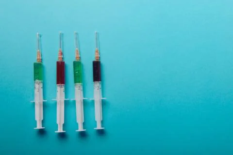 Syringe on blue background. Stock Photos