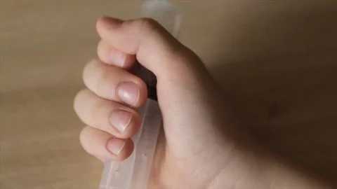 Syringe in child's hand, close-up Stock Footage 73548839