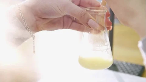 Syringe containing yellow liquid on a table in laboratory, For prepared Stock Footage 73892907