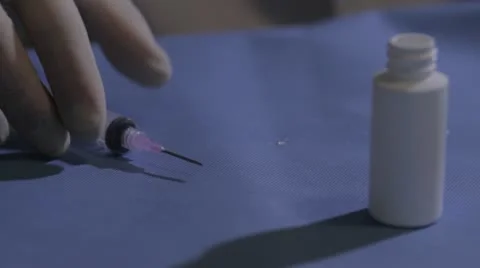 Syringe drawing out clear fluid Stock Footage 20446451