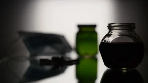 The syringe draws liquid from the flask Stock Footage 125490421