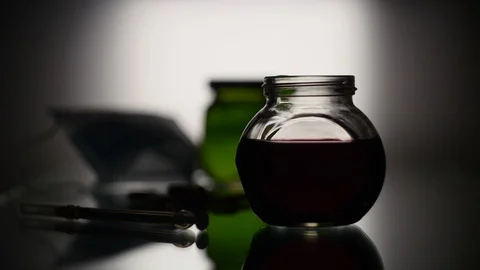 The syringe draws liquid from the flask Stock Footage 125490526