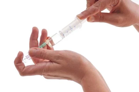 Syringe in hand Stock Photos