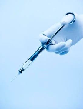 Syringe in hand Stock Photos