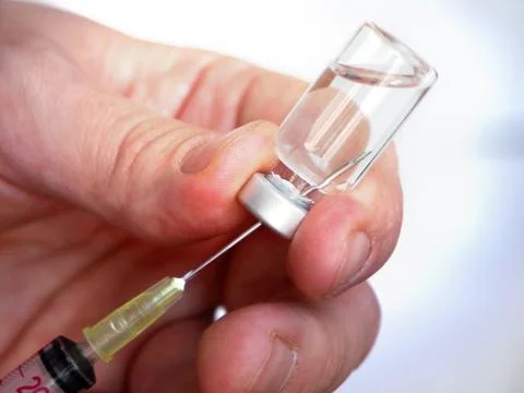 Syringe with hand Stock Photos