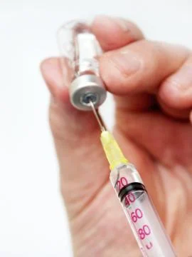 Syringe with hand Stock Photos