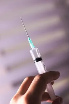 Syringe in hand Stock Photos
