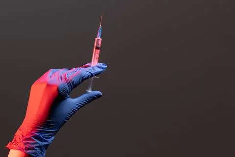 A syringe with an injectable solution on a black background with a copy space. A Stock Photos