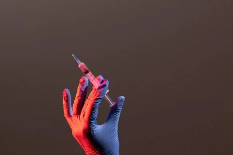 A syringe with an injectable solution on a black background with a copy space. A Stock Photos