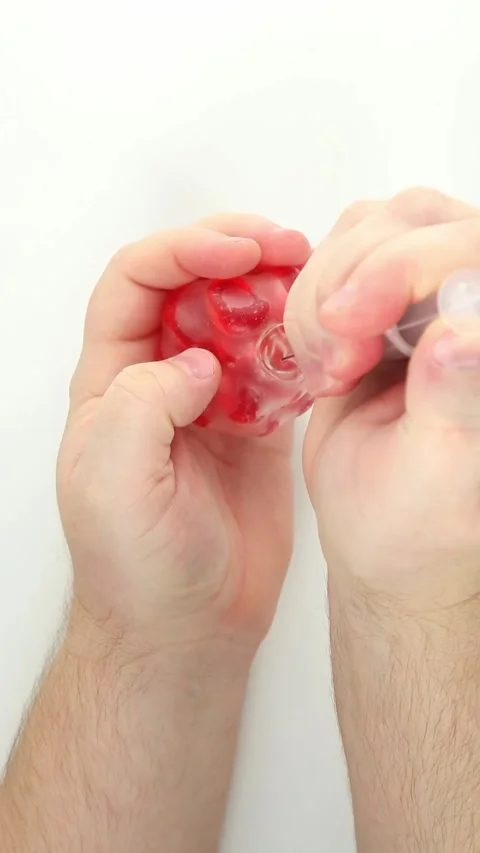Syringe injecting and squeezing red bubble gel stress ball closeup Video stock 336265025