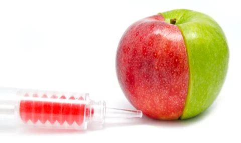 Syringe injection in an apple Stock Photos