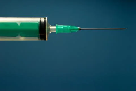 Syringe for injection on a blue background. Stock Photos