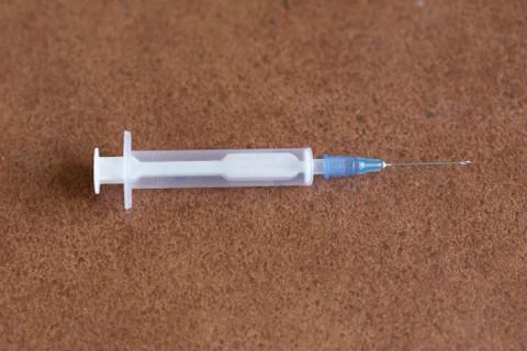 Syringe for injection on a brown background Stock Photos