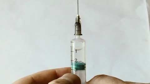 Syringe for injection in hands Stock Footage 78912866