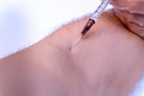 Syringe injection process in a hand close up Stock Photos