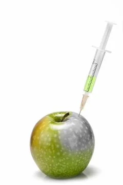 Syringe inserted in  an apple. Stock Photos