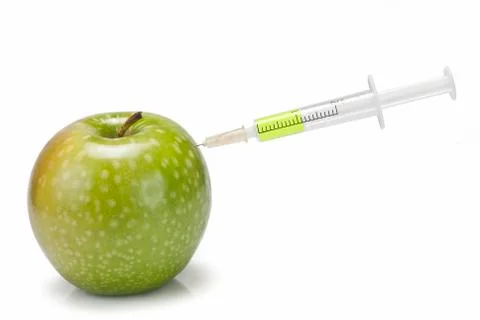 Syringe inserted in  an apple. Stock Photos