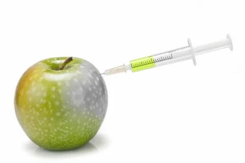 Syringe inserted in  an apple. Stock Photos