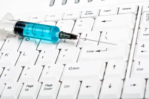 Syringe on keyboard Stock Photos