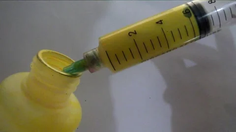 Syringe with liquid in color yellow Video stock 48714412