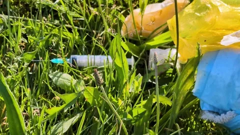 The syringe is lying among the grass Stock-Footage 335799772