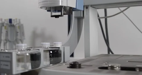 Syringe machine filling test tubes with transparent liquid Stock Footage 104821058