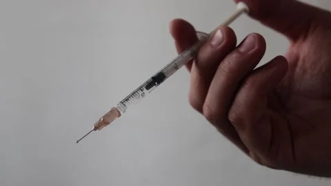 Syringe in a man's hand Stock Footage 140143967