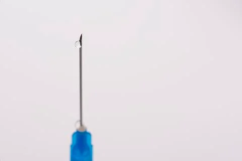 Syringe needle with a drop Stock Photos