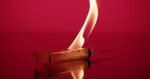Syringe needle on fire, Red Abstract background. Vaccine, dangerous, biohazard 스톡 동영상 151758279