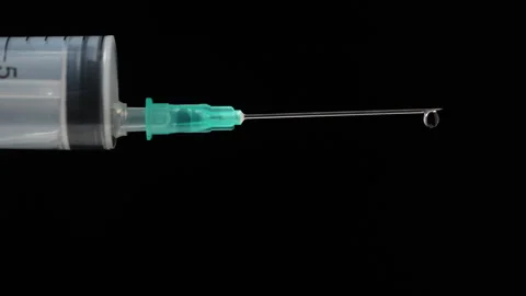 Syringe needle with an injection solution. Syringe with vaccination, close up Stock Footage 304041528