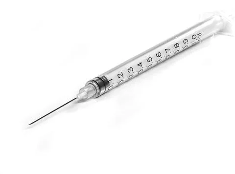 Syringe with needle on white background, reflection in the base - macro photo Stock Photos