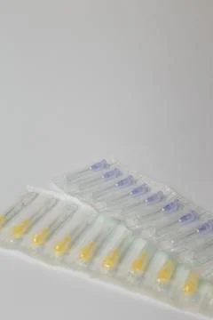 Syringe needles set in plastic package on white background. Medical equipment Stock Photos