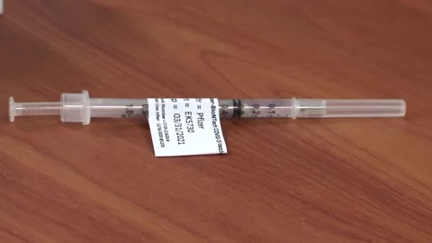 Syringe with Pfizer BioNTech COVID 19 Vaccine Video stock 145148746
