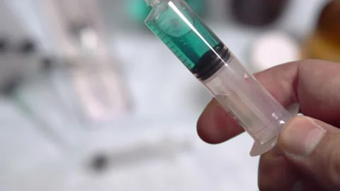 Syringe pulling a bit of blood. Mixing a drug with the blood. Video stock 142720910