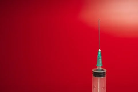 Syringe on a red background Stock Photos