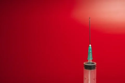 Syringe on a red background Foto stock