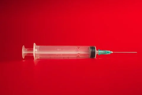 Syringe on a red background Foto stock
