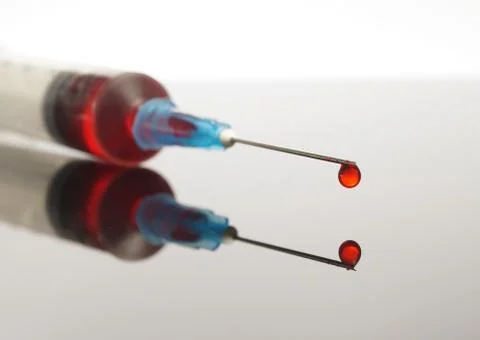 Syringe with red drop Stock Photos