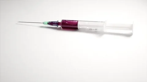 Syringe of red liquid falling and bouncing on white surface 2 Stock-Footage 77644698