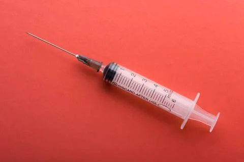 Syringe on red Stock Photos