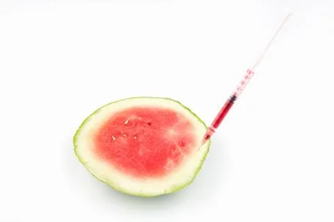 Syringe in split watermelon on white background Stock Photos