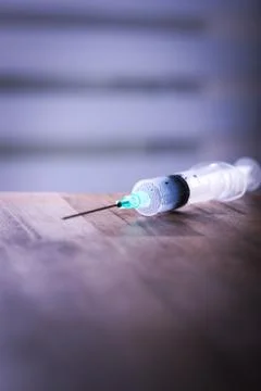 Syringe on table Stock Photos
