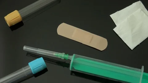 Syringe with test tubes on black background 스톡 동영상 85948049