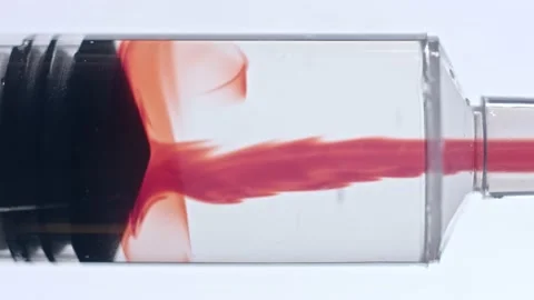 Syringe tube pulling red solution against white background clinical vaccine Stock Footage 146479912