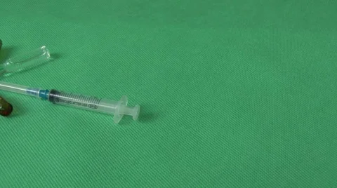 Syringes and vials on a green background Stock Footage 59125077