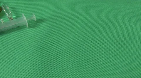 Syringes and vials on a green background Stock Footage 59125306