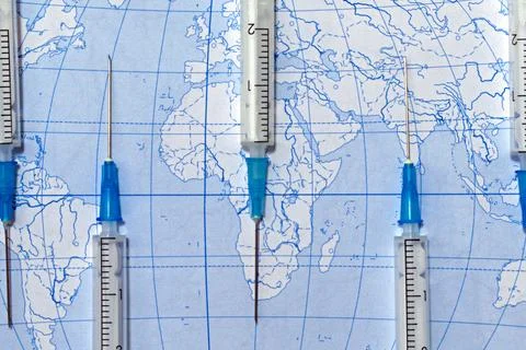 Syringes on background of world map Stock Photos