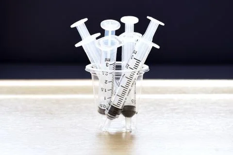 Syringes in cup Stock Photos