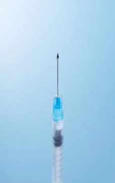Syringes placed on a blue background Stock Photos
