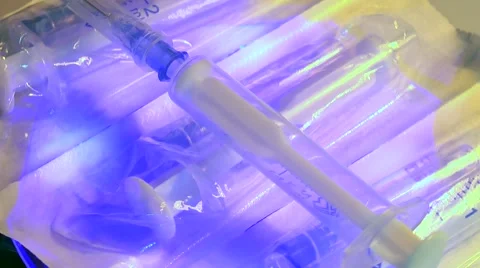 Syringes rotate on the table with backlight Stock Footage 60048896